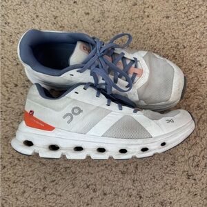 On Running White and Orange Athletic Shoes